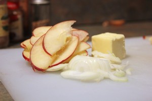 Sliced apples, onions and a tbsp of butter ready to go into pan